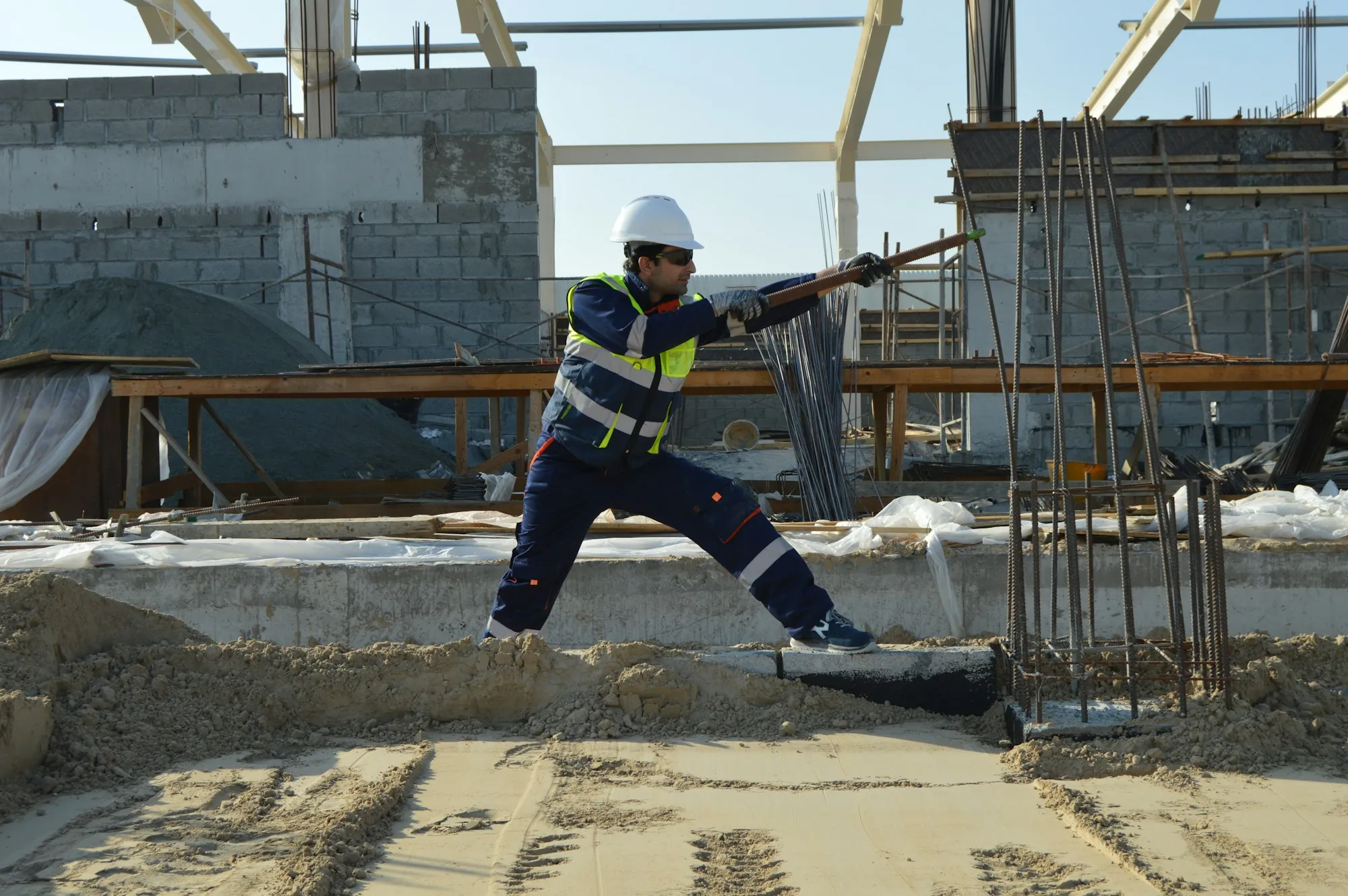 Worker at a foundation wall with rebar dowels