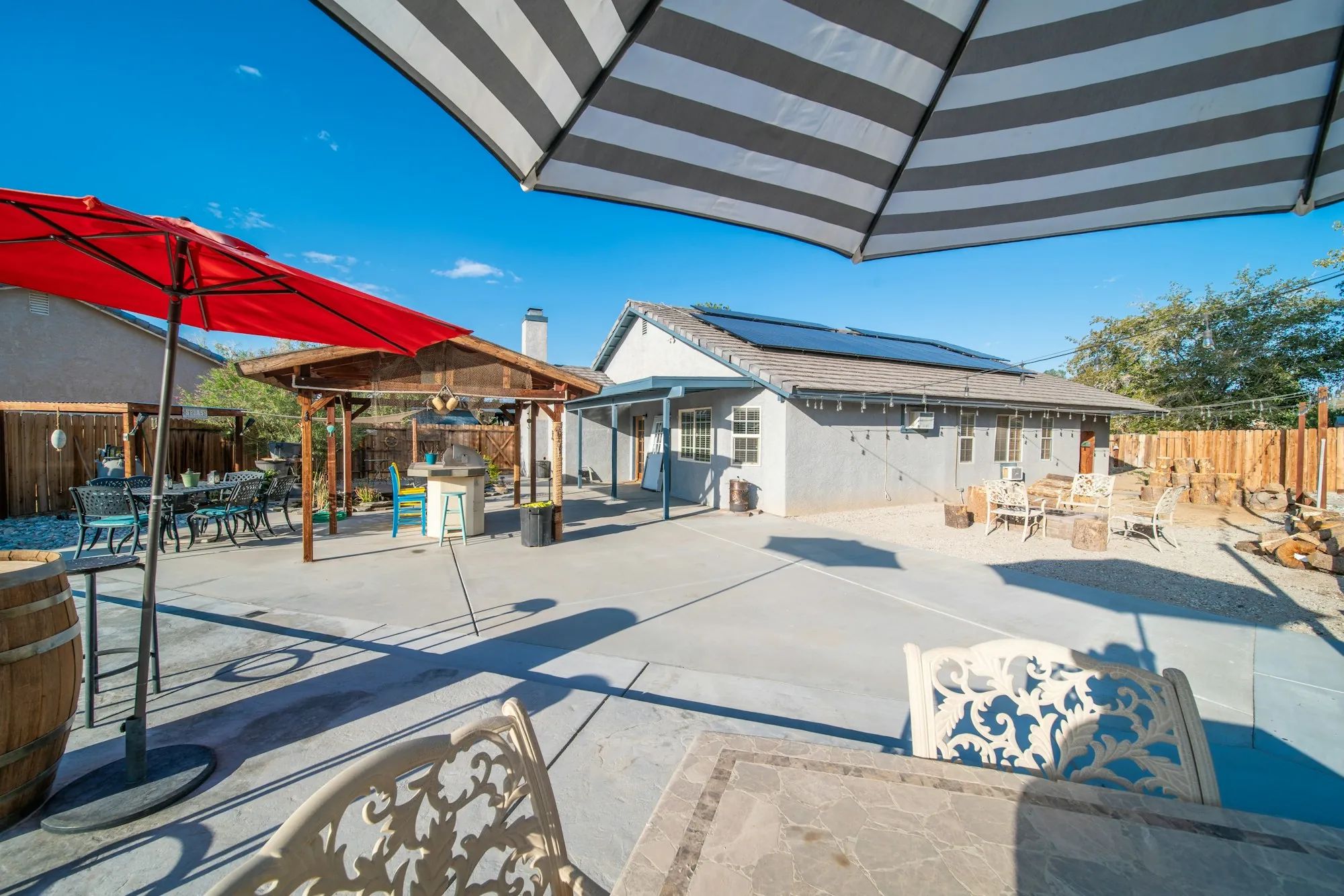 Large concrete patio with umbrellas and outdoor seating